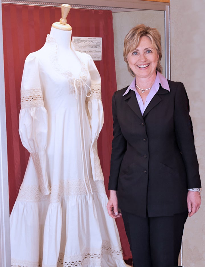 Hillary poses with a replica of her wedding gown at the Clinton House Museum in Fayetteville, Arkansas.