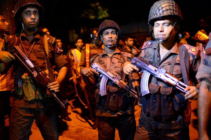 Bangladeshi security stand guard near a restaurant under attack by gunmen in the early hours of July 2, 206 in Dhaka, Bangladesh.