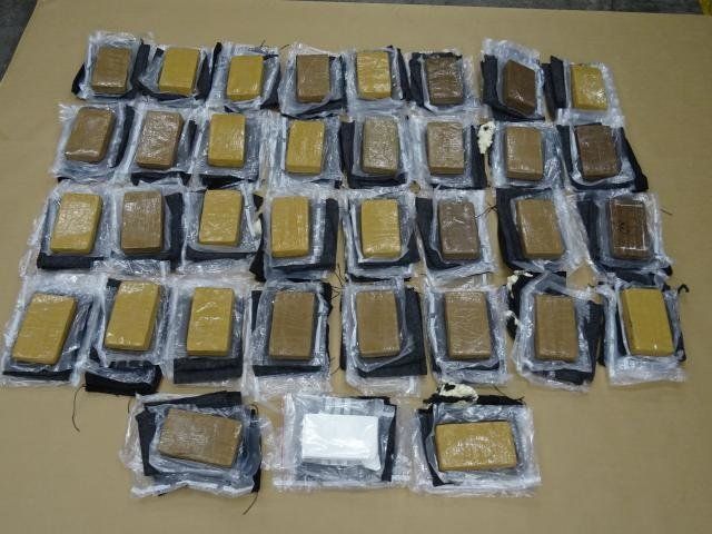 Police and customs officials found these 35 bricks of high-grade cocaine after opening up the artwork.