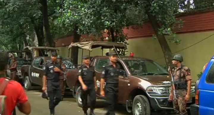 Rapid Action Battalion members walk as police stormed the Holey Artisan restaurant after gunmen attacked it and took hostages early on Saturday in Dhaka, Bangladesh in this still frame taken from live video July 2, 2016