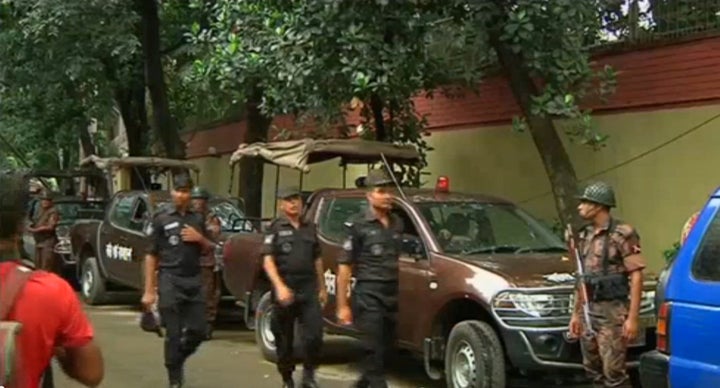 Rapid Action Battalion members walk as police stormed the Holey Artisan restaurant after gunmen attacked it and took hostages early on Saturday in Dhaka, Bangladesh in this still frame taken from live video July 2, 2016