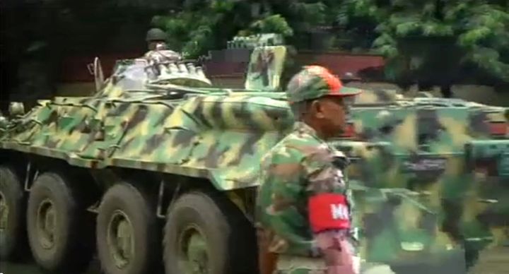 An army armoured vehicle moves along a street as police stormed the Holey Artisan restaurant after gunmen attacked it and took hostages early on Saturday in Dhaka, Bangladesh in this still frame taken from live video July 2, 2016.