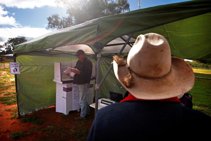 People vote in the remote polling station in the western New South Wales outback last week. With half the votes counted, the country looked set for a hung parliament or minority government.