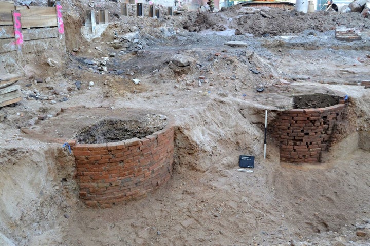 Two of the 12 brick-lined privies that were uncovered are seen. These vaults were used as outhouses and garbage receptacles.