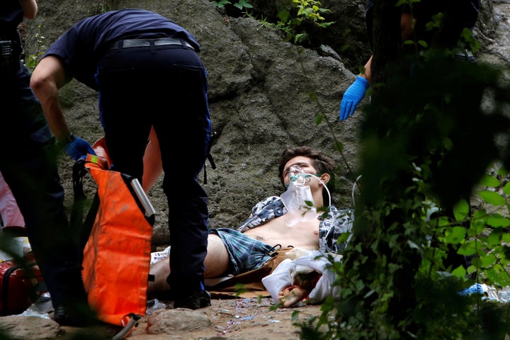 Medics stand over a man who was injured after an explosion in Central Park, in Manhattan, New York.