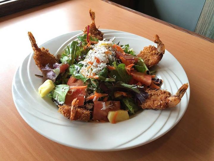 Coconut Shrimp Salad:mixed greens, tomatoes, pineapple, shredded carrots, toasted coconut, Caribbean mango dressing topped with coconut shrimp