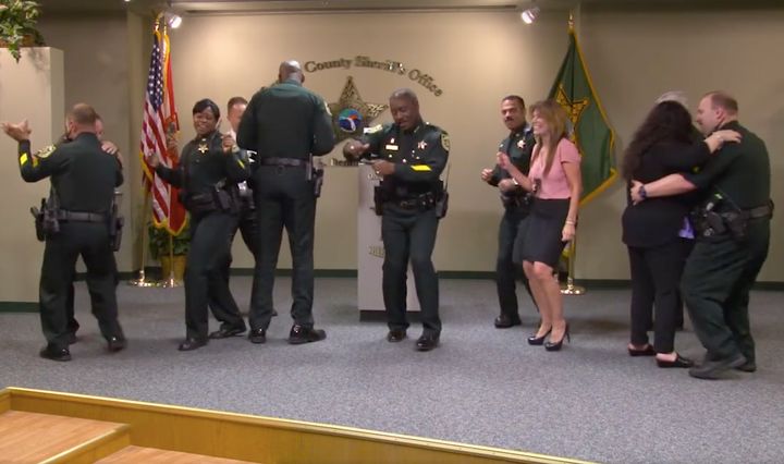 Orange County Sheriff Jerry Demings breaks into dance with his staff after calling a press conference.
