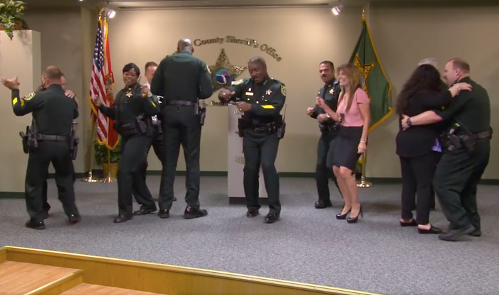 Orange County Sheriff Jerry Demings breaks into dance with his staff after calling a press conference.