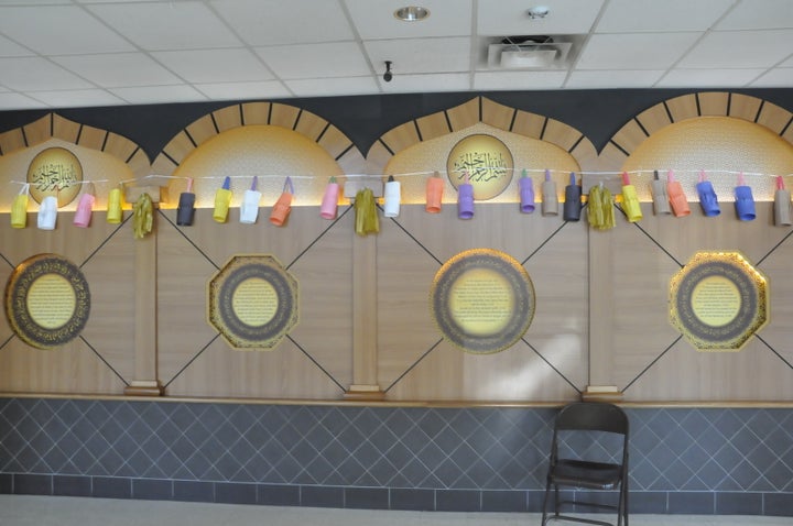 Children decorate a Masjid with paper lanterns