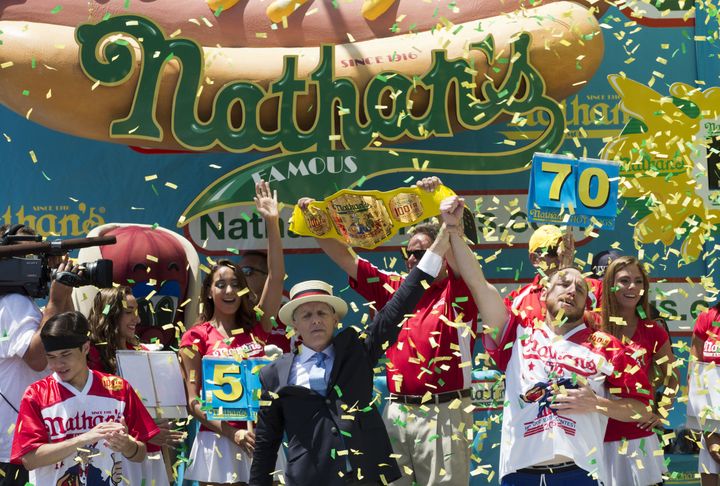 Joey Chestnut, right, is declared Nathan's Famous Fourth of July International Hot Dog Eating Contest men's division winner on Monday.