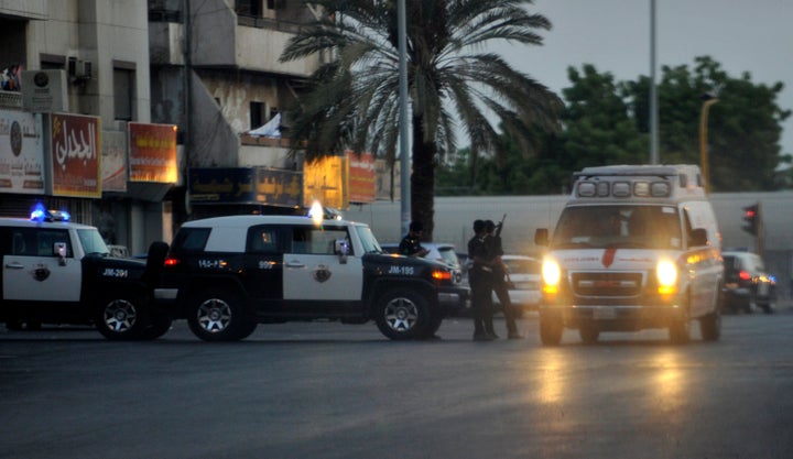 Saudi policemen stand guard at the site where a suicide bomber blew himself up in the early hours of July 4, 2016.