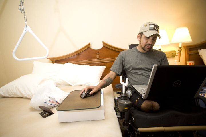 Iraq war veteran SGT Luis Rosa-Valentin, who lost both of his legs, left arm and hearing while serving in Iraq plays video games while recuperating in the Mologne House at Walter Reed Army Medical Center in Washington, DC on July 30, 2008. He loves games strategy and first-person shooter games like 'Ghost Recon' but finds them much more difficult to play with one hand. His encounter with the improvised explosive device that almost ended his life came in April, during his second tour in the combat zone. Rosa-Valentin is still recovering at Walter Reed. He speaks of his time in the Army with no regrets. ' I was born for it, really, I loved every second of it, he said. Despite my injuries, I still don't care, I love it. I love the infantry, I love the life that I led. I wouldn't trade a second of it for anything else'.