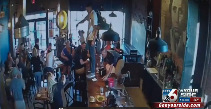 A man is seen standing on an Idaho restaurant's bar counter, where he was heard proclaiming his love for Allah.