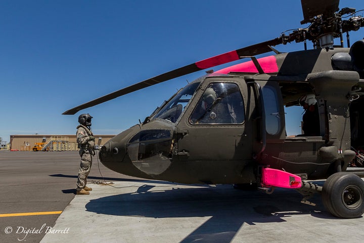 Specialist Christopher Hobbs, Crew Chief, assists the pilots in final checks before take off.