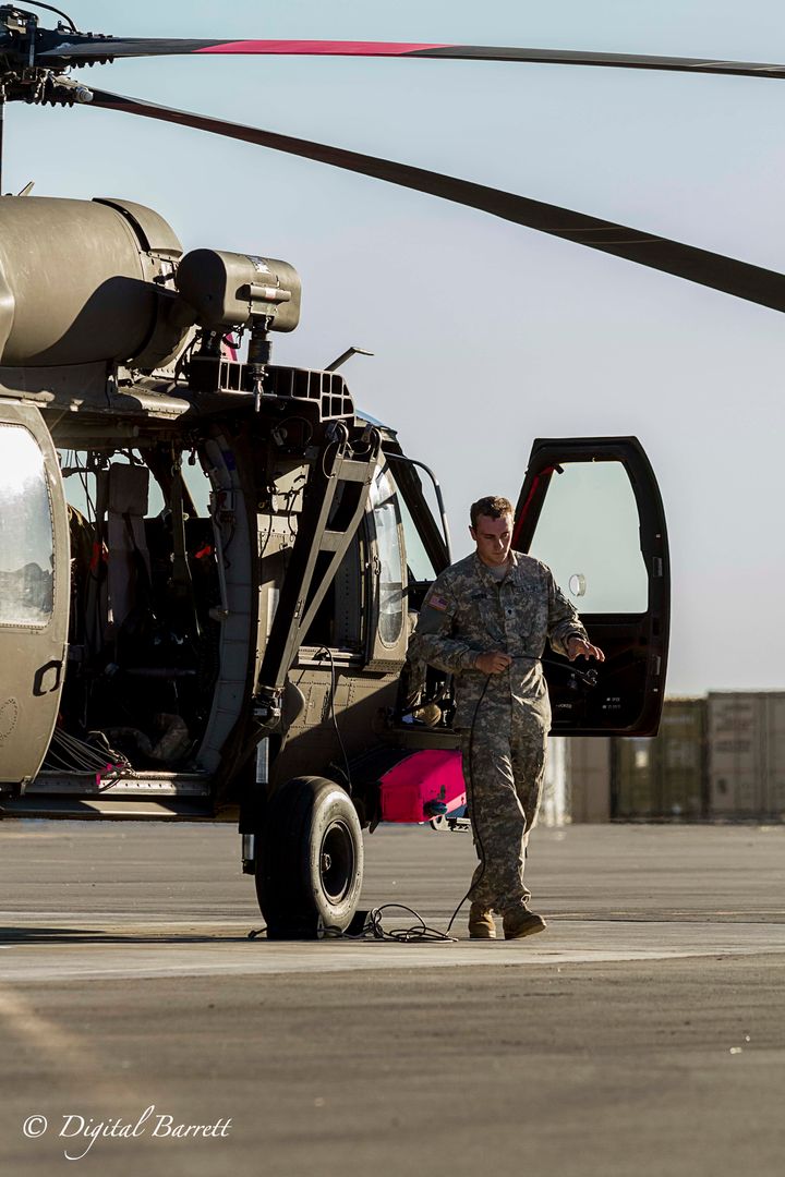 Specialist Christopher Hobbs resets the Black Hawk after a long day of flying.