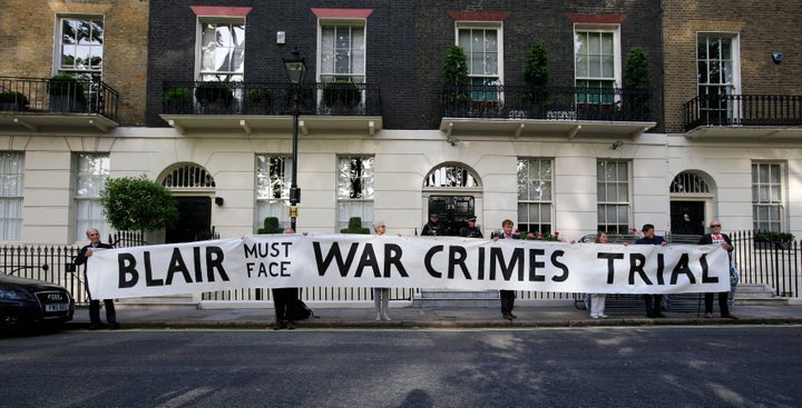 Protesters hold a banner outside the London home of former Prime Minister Tony Blair ahead of the publication of the Chilcot report into the Iraq war.