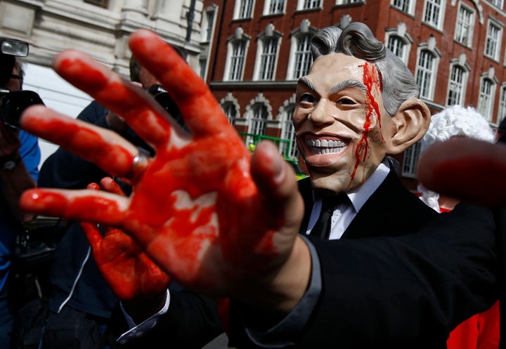 A demonstrator wearing a mask to impersonate Tony Blair protests before the release of the Chilcot report into the Iraq war,
