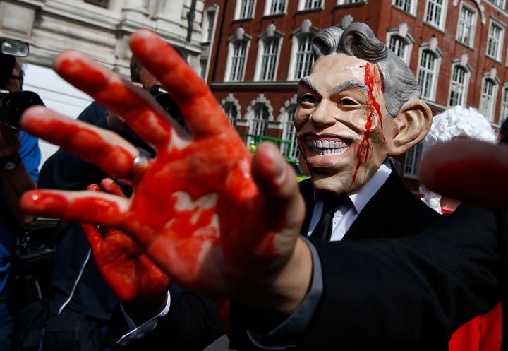 A demonstrator wearing a mask to impersonate Tony Blair protests before the release of the Chilcot report into the Iraq war, at the Queen Elizabeth II centre in London on Wednesday.