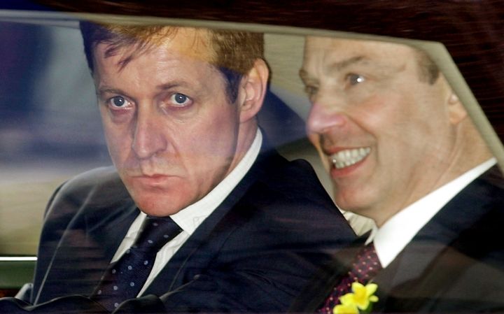 <strong>Campbell pictured peering out of Prime Minister Tony Blair's vehicle while he worked for him between 1997 and 2003</strong>