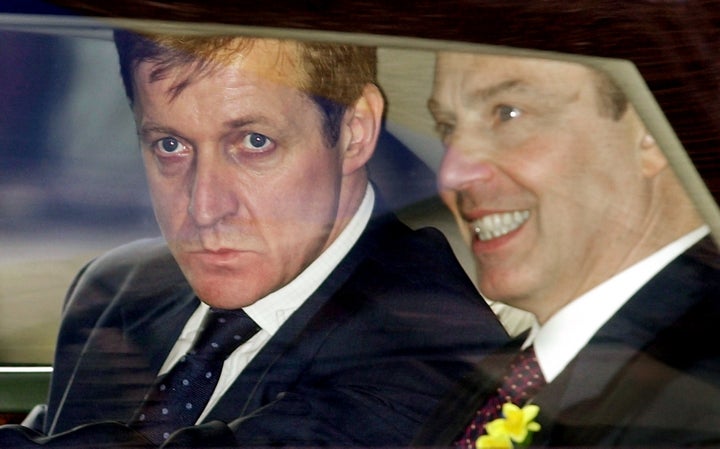 <strong>Campbell pictured peering out of Prime Minister Tony Blair's vehicle while he worked for him between 1997 and 2003</strong>