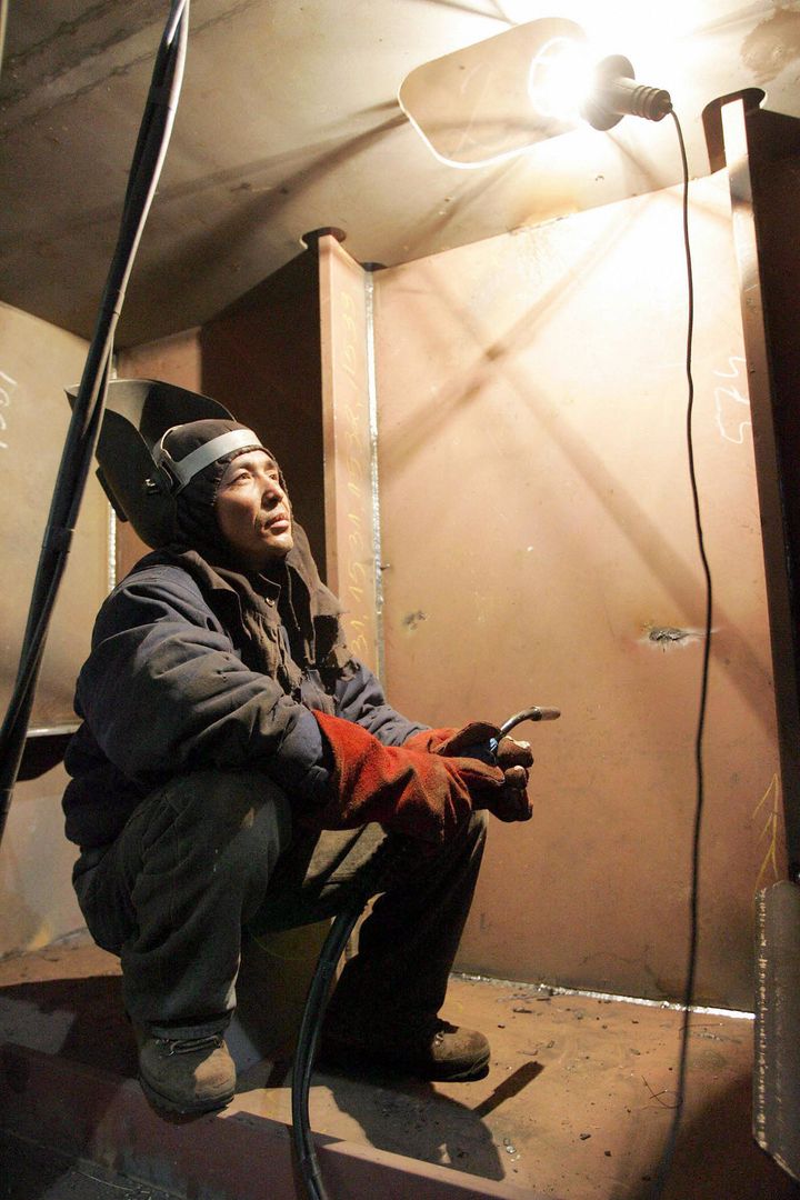 Most of the North Korean laborers sent abroad are working in Polish shipyards, construction sites and farms. Pictured here, a North Korean welder works in a Gdansk shipyard in March 2006.