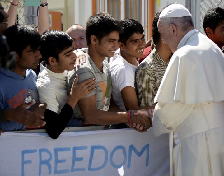 Pope Francis greets young migrants and refugees at the Moria refugee camp on the Greek island of Lesbos on April 16, 2016.