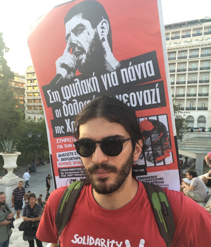 The sign on Minas Chronopoulos' back features Pavlos Fyssas, a radical anti-fascist rapper slain by members of the neo-Nazi Golden Dawn party in 2013.