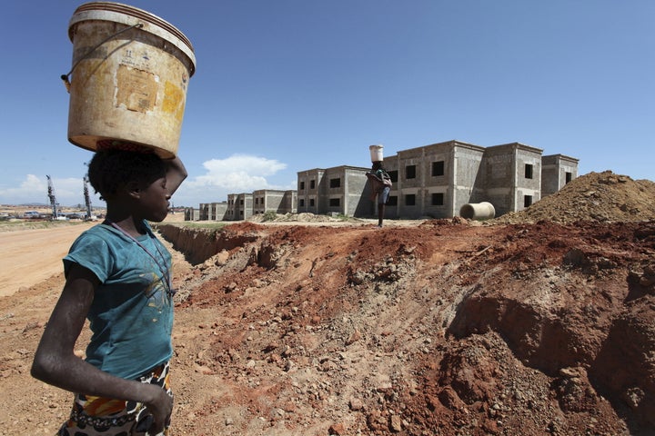 A woman walks past a Chinese construction site in Lubango, Angola. 