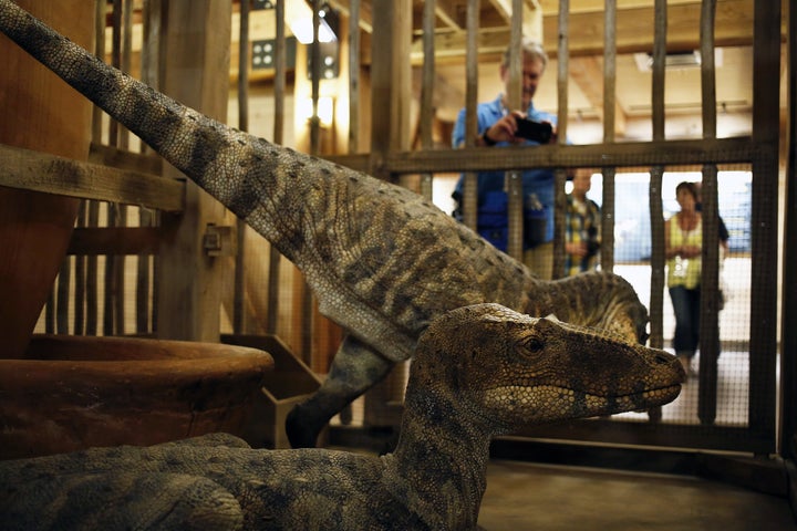 Dinosaurs on display in a cage at the Ark Encounter in Kentucky. The creationist behind the attraction claims dinosaurs and man lived together.