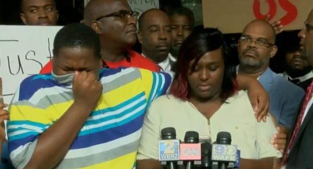 15-year-old son of Alton Sterling, a black man who was shot and killed by white police officers in Baton Rouge, Louisiana, weeping at his family's press conference