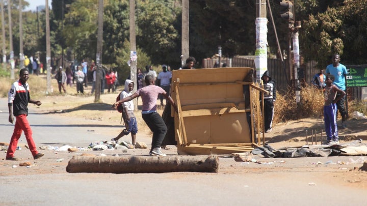 Protestors block a road leading to the city following a job boycott started via social media platforms in Harare on July 6, 2016.