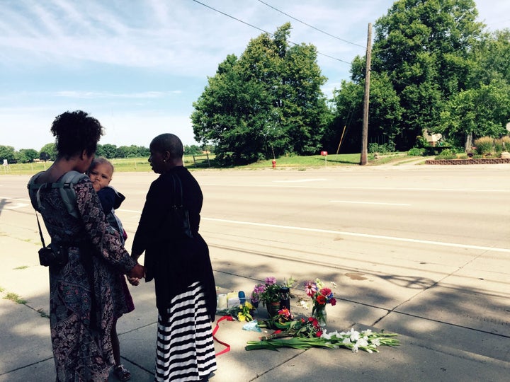 Pastor Patricia Bell (right) of St. Paul prays on July 7, 2016, with Gabriella Dunn and her children Oakland, 1, and Chloe, 4, at the scene where Philando Castile was shot and killed by police.