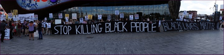 Black Lives Matter demonstrators gather outside the Barclays Centre in New York on the one-year anniversary of Michael Brown, who was killed by a suburban St. Louis police officer in 2014.