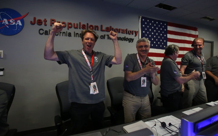 Scott Bolton (L), NASA principal investigator for the Juno mission to Jupiter, reacts as the Juno spacecraft successfully enters Jupiter's orbit on July 4, 2016, at the Jet Propulsion Laboratory in Pasadena, California.