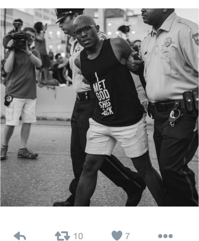 A black, gay Harlem pastor being arrested for civil disobedience after failing to disperse from obstructing a highway entranc