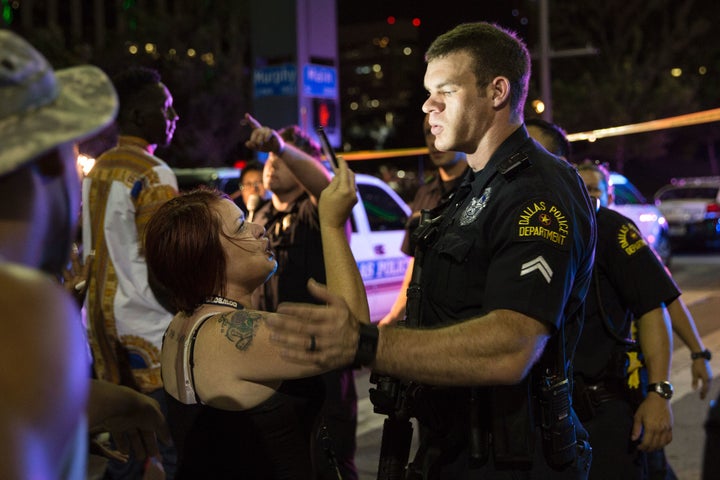 Police attempt to calm the crowd as someone is arrested following the sniper shooting in Dallas on Thursday.