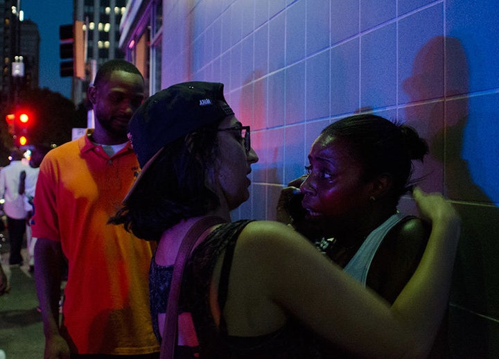 Two witnesses embrace after a Dallas anti-police brutality protest was hit by sniper fire. 