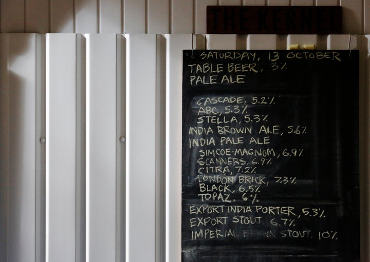 A list of beers and their average alcohol volumes are written on a chalk board at The Kernel micro-brewery in London, October 2012.