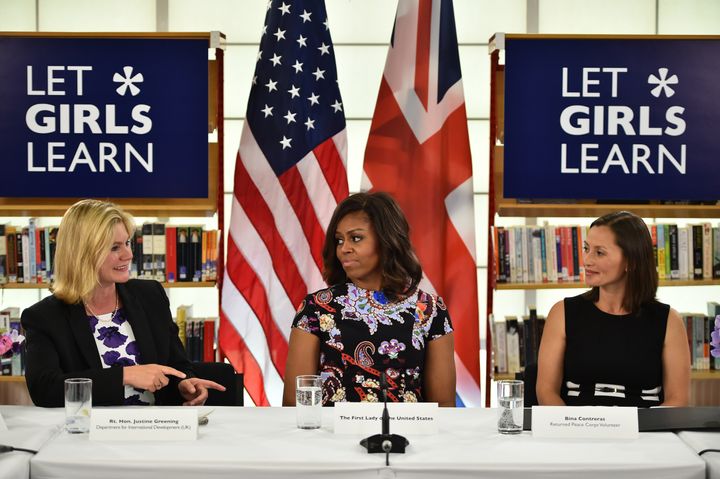 LONDON, ENGLAND - JUNE 16: US First Lady Michelle Obama (C) sits between The UK Department of International Development's Justine Greening and (L) returned Peace Corps Volunteer Bina Contreras (R) during a 'Let Girls Learn' meeting as part of the 'Let Girls Learn Initiative' at the Mulberry School for Girls on June 16, 2015 in London, England. The US First Lady is travelling with her daughters, Malia and Sasha and her mother, Mrs. Marian Robinson, to continue a global tour promoting her 'Let Girls Learn Initiative'. The event at the school was to discuss how the UK and USA are working together to expand girl's education around the world. (Photo by Jeff J Mitchell/Getty Images)