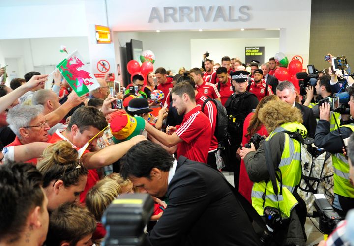 <strong>The Wales team arrive at Cardiff Airport to a heroes welcome after their historic performance at Euro 2016</strong>