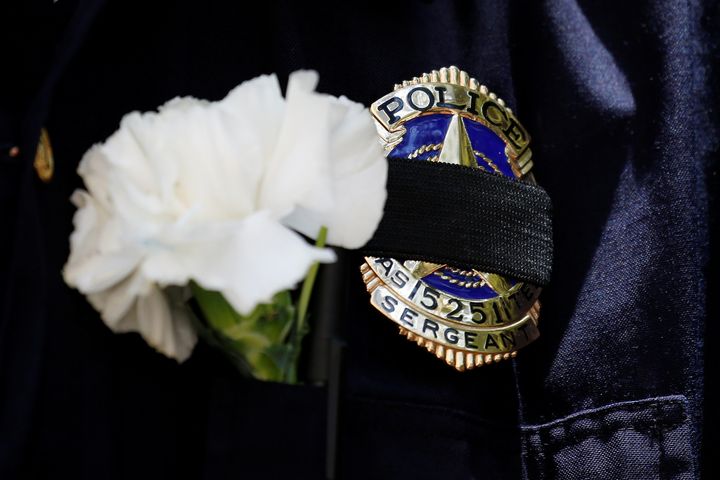 A Dallas police sergeant wears a mourning band on his badge during a prayer vigil on July 8, 2016.