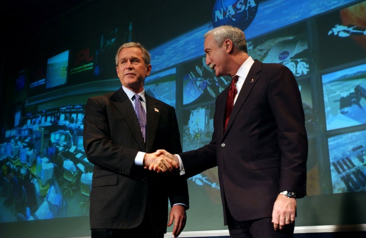 NASA administrator Sean O’Keefe shakes hands with President Bush at NASA Headquarters in January 2004, where Bush unveiled a new vision for the nation’s human spaceflight program in the wake of the Columbia accident. 