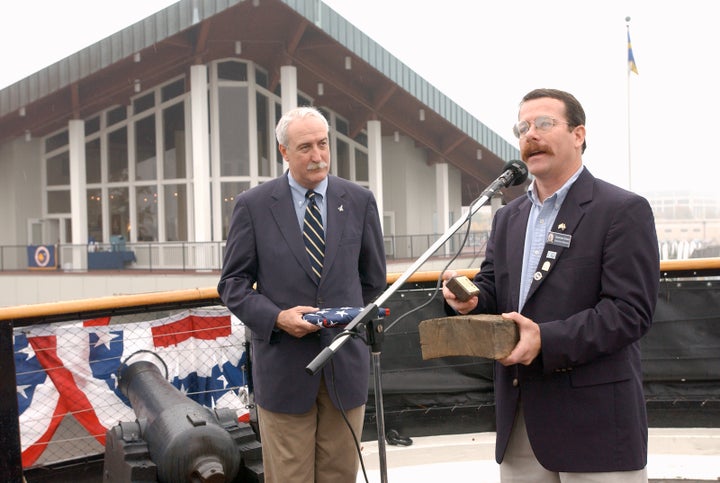 <em>NASA administrator Sean O’Keefe (left) accepts a wooden plank from the historic sailing ship USS Constellation. Constellation became the name of the program that would carry out President Bush’s Vision for Space Exploration.</em>
