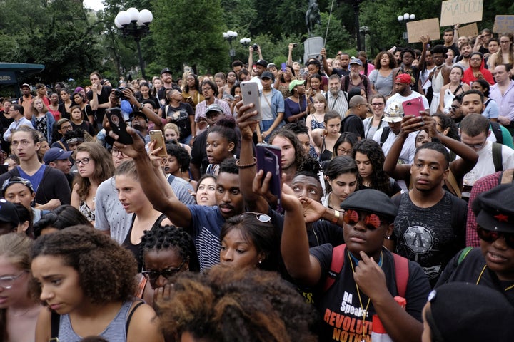 People take part in a protest against the killing of Alton Sterling, Philando Castile and in support of Black Lives Matter during a march along Manhattan's streets in New York July 8, 2016.