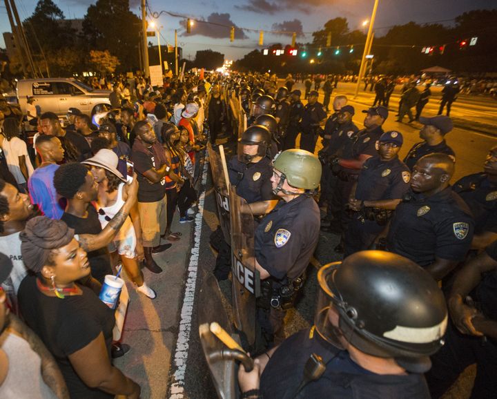 Protesters face off with Baton Rouge police in riot gear across the street from the police department on July 8, 2016 in Baton Rouge, Louisiana.