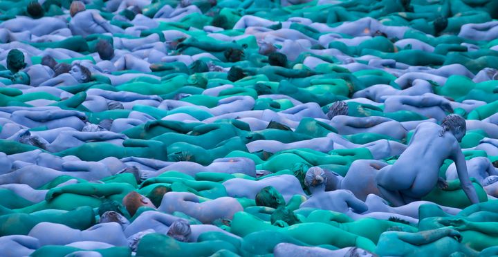 Naked volunteers, painted in blue to reflect the colors found in Marine paintings in Hull's Ferens Art Gallery, participating in artist Spencer Tunick's "Sea of Hull" installation on the Scale Lane swing bridge in Hull on Saturday.
