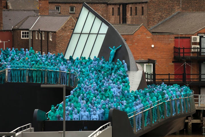 Naked volunteers have their bodies painted in blue to reflect the colors found in Marine paintings in Hull's Ferens Art Gallery.