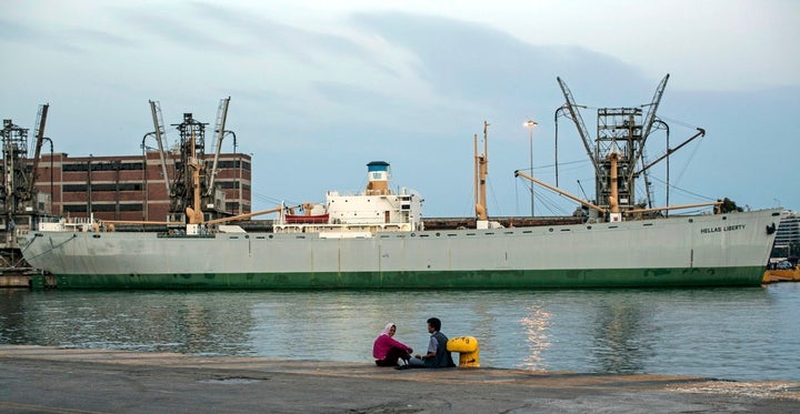An Afghan couple sit waiting out the end of the day at the docks of Athens’ port of Piraeus. They have spent approximat
