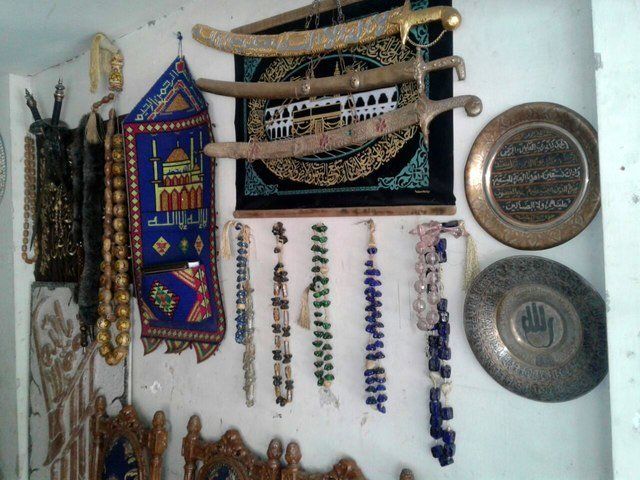 Antique decorative objects hang on the wall in Abu Abdo's shop. Eastern Ghouta, June, 2016.
