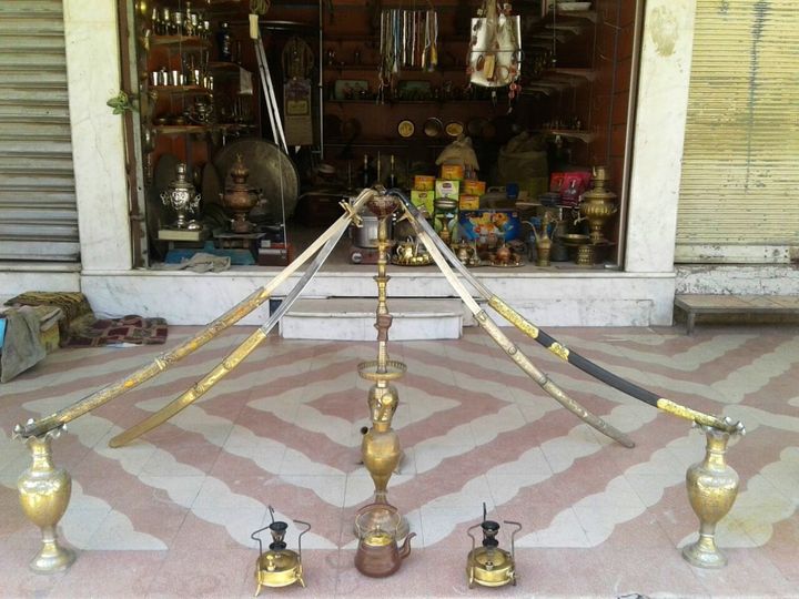 A 100-year-old hookah bowl with four ancient swards on display in front of Abu Abdo’s shop. Eastern Ghouta, June, 2016.